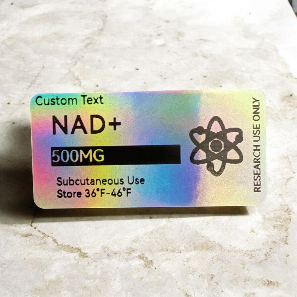 A rectangular holographic label with rounded corners featuring black text that reads Custom Text, NAD+, 500MG, Subcutaneous Use, Store 36°F-46°F, and RESEARCH USE ONLY, alongside a black atom icon on the right side of the iridescent surface.